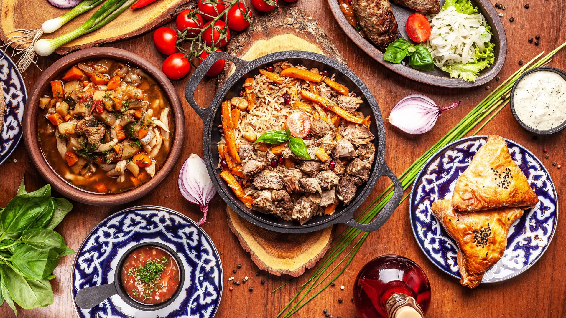 Traditional Uzbek oriental cuisine. Uzbek family table from different dishes for the New Year holiday. The background image is a top view.